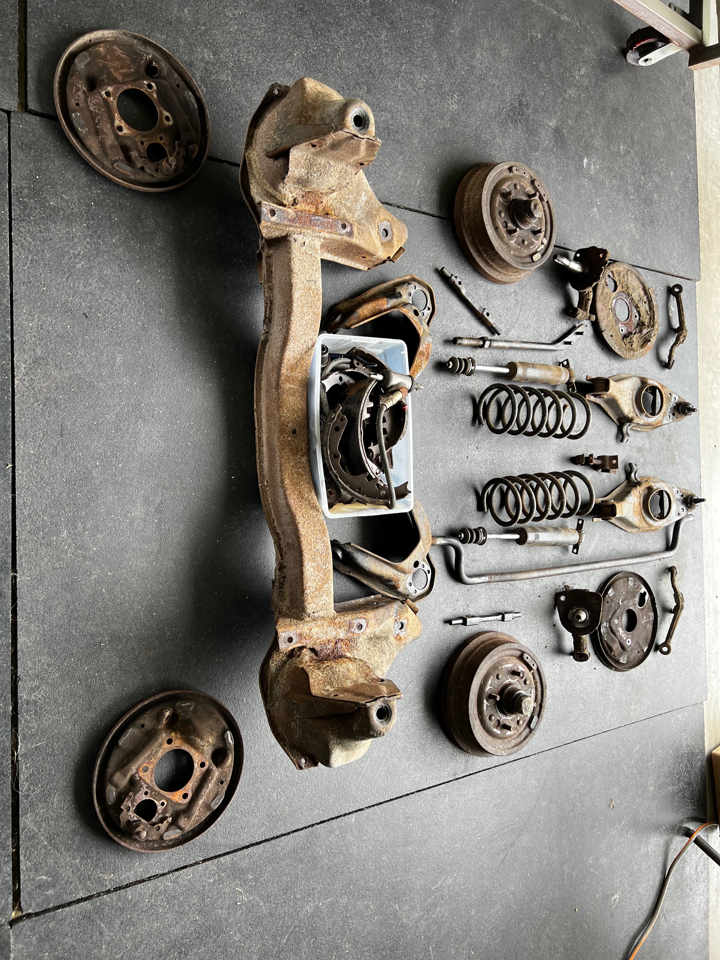 1964 Corvair disassembly progress showing stripped chassis