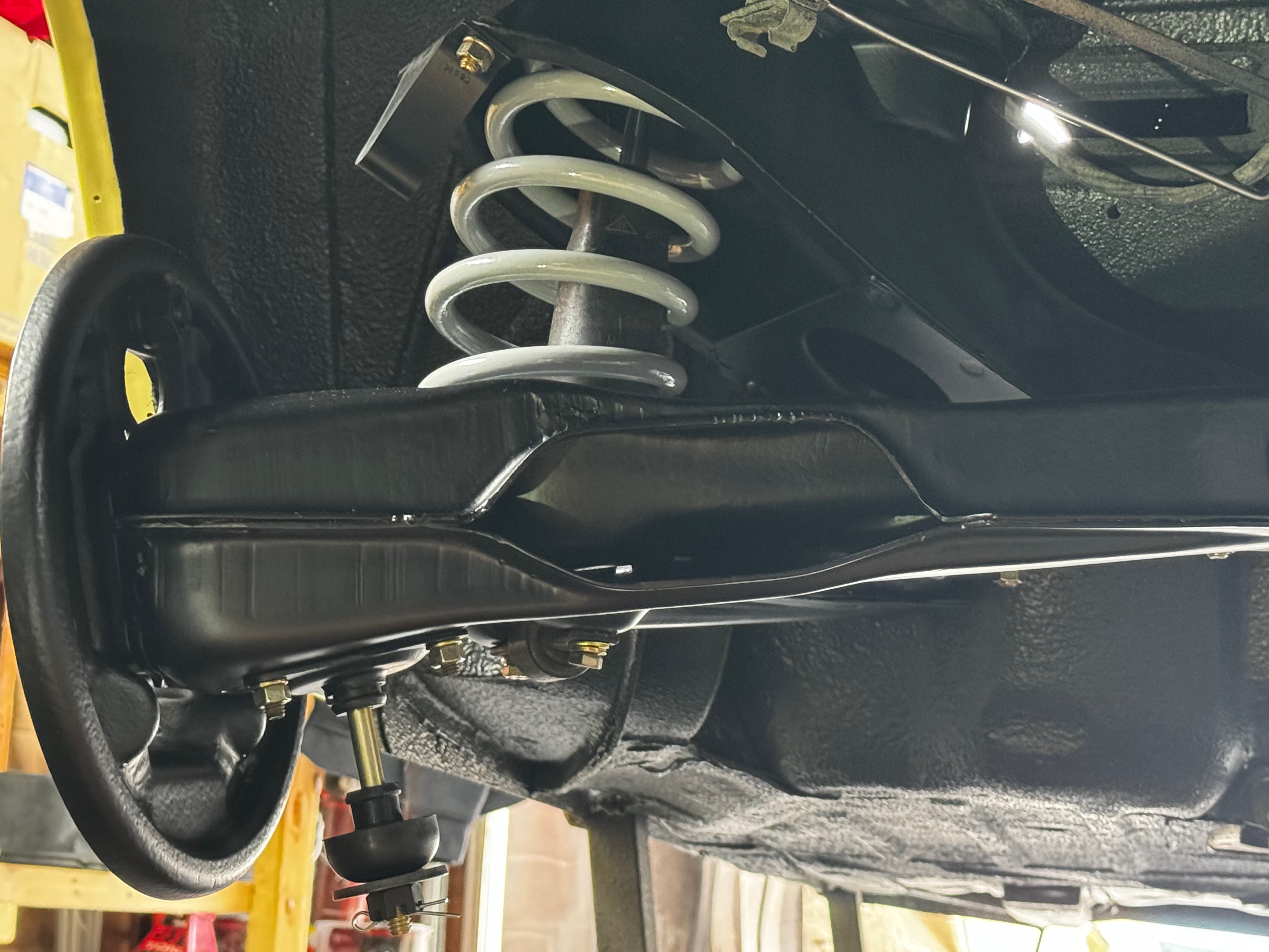 1964 Corvair chrome bumper installation during reassembly phase
